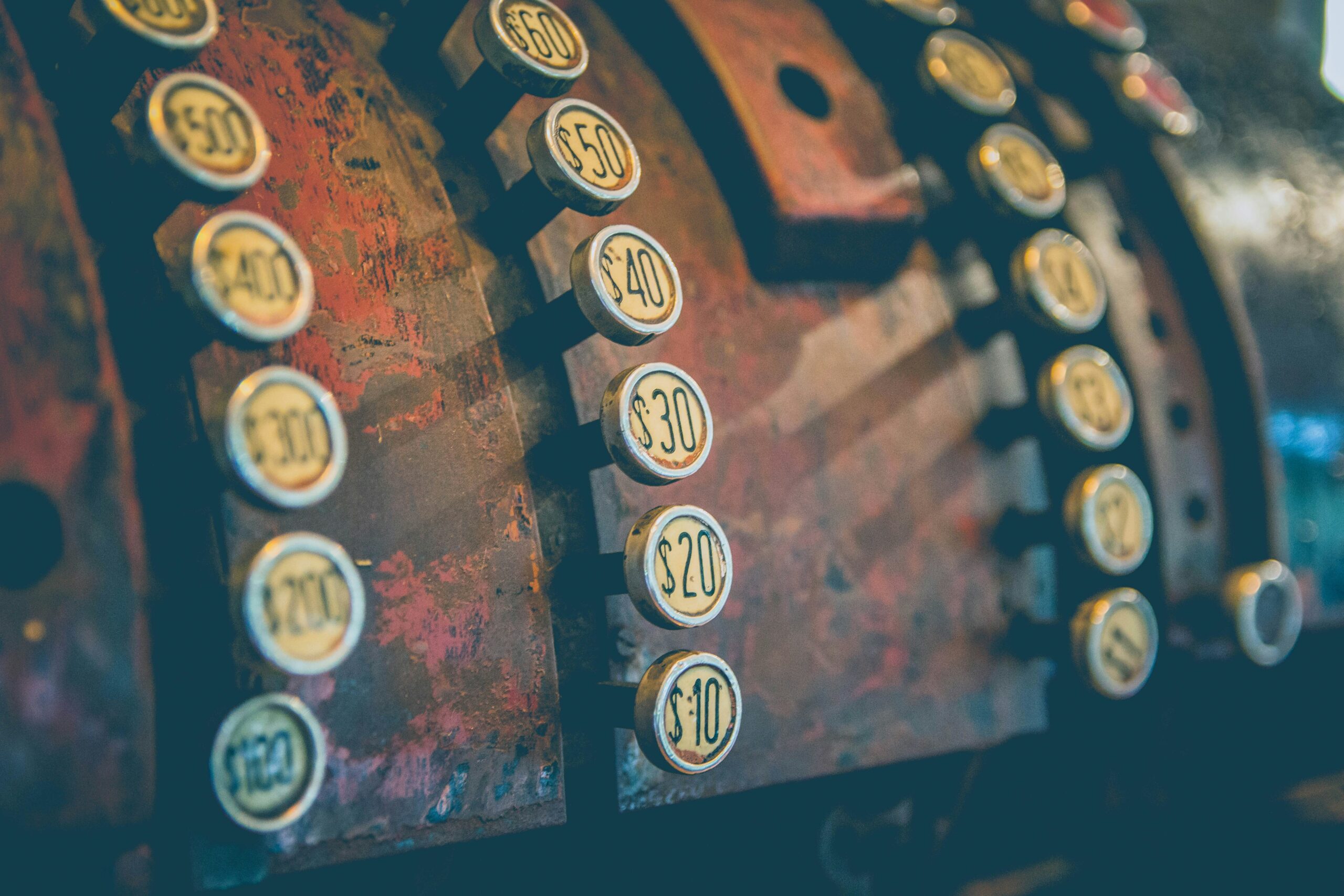 Close-up view of a machine featuring numerous buttons, showcasing its intricate control panel and design.